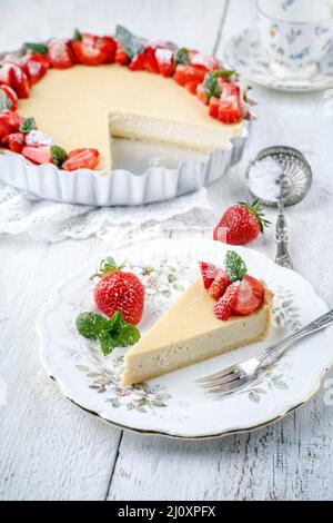 Traditional German cheesecake with strawberry fruits served as close-up on a classic design plate with tablecloth Stock Photo