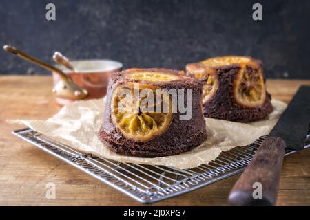Traditional orange chocolate cake offered as close-up on wooden board Stock Photo