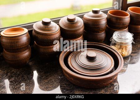 Set of clay dishes on wooden table. Space for text Stock Photo