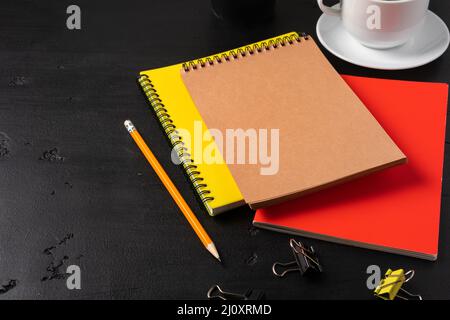 Three notepads on a black table close up Stock Photo