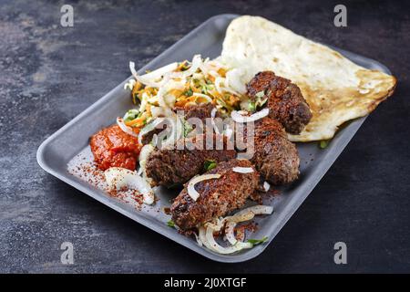Traditional Croatian cevapi spicy meat ball rolls with cabbage carrot salad Stock Photo