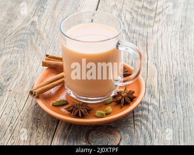 Masala Indian drink in the festival of Holi. Tea with milk and spices in a glass mug. Stock Photo