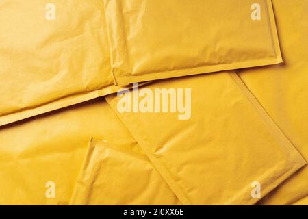 Lot of yellow paper postal envelopes. Top view. Stock Photo