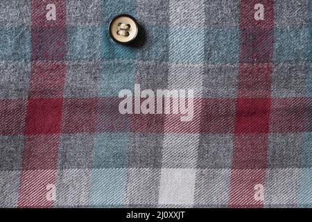 Button on a cloth with plaid pattern Stock Photo
