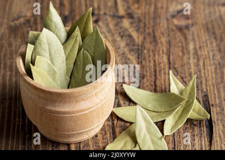 High angle wooden bowl with bay leaves. High quality photo Stock Photo