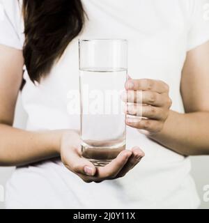 Crop female hands holding glass water. High quality photo Stock Photo