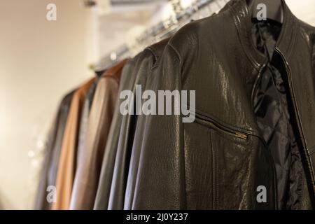 Collection of leather jackets in shop Stock Photo