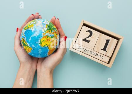 Top view hands holding earth globe calendar. High quality photo Stock Photo