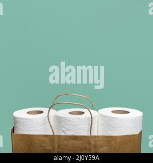 Front view three toilet paper rolls paper bag. High quality photo Stock Photo