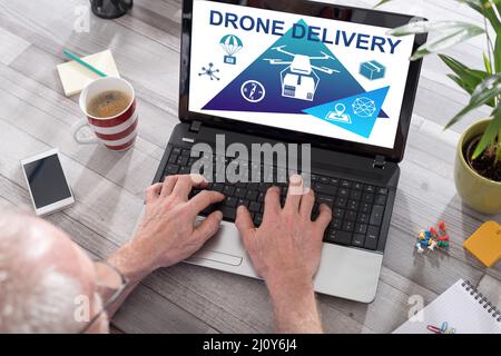 Drone delivery concept shown on a laptop used by a man Stock Photo