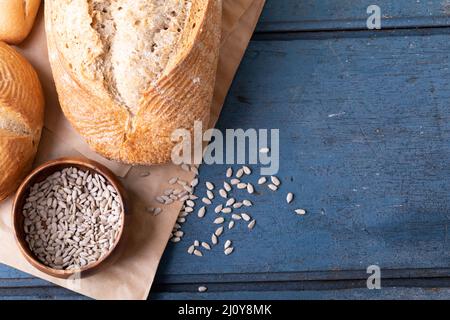 Close up view of different types of breads and pumpkin seeds with copy space on wooden surface Stock Photo