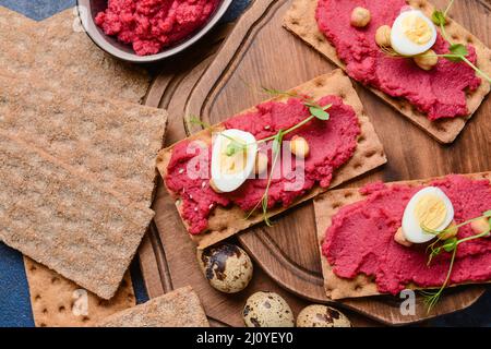 Crispbreads with tasty hummus on table Stock Photo