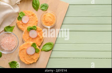 Crispbreads with tasty hummus and salt on table Stock Photo