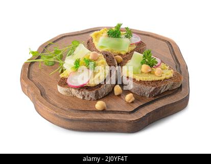 Board with pieces of bread and tasty hummus on white background Stock Photo