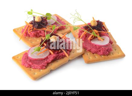 Crispbreads with tasty beetroot hummus on white background Stock Photo
