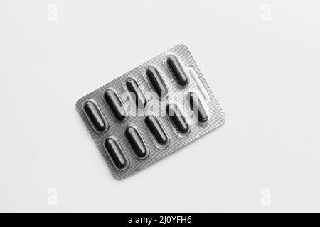 Blister package of activated carbon capsules on grey background Stock Photo