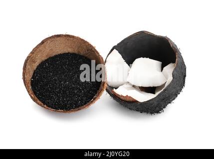 Coconut shells with activated carbon on white background Stock Photo
