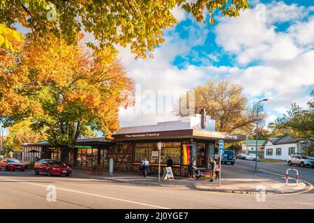 Adelaide Hills, South Australia - April 24, 2021: Small shops viewed along the street in Hahndorf during the autumn season at sunset Stock Photo