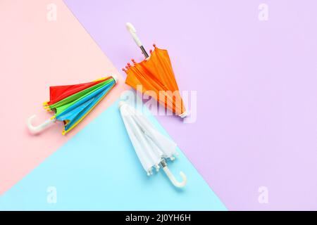 Three umbrellas on color background Stock Photo