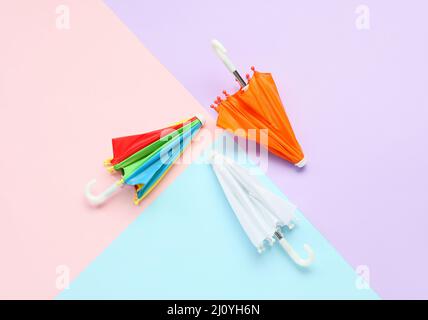 Three umbrellas on color background Stock Photo