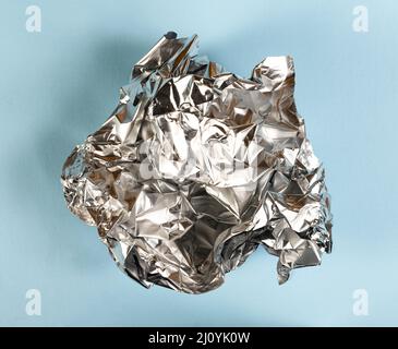 the tinfoil crumpled onto a colored surface Stock Photo