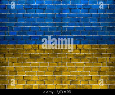 Ukraine flag colors painted on the urban brick wall during war Stock Photo