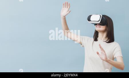 Front view woman experiencing virtual reality. High quality photo Stock Photo