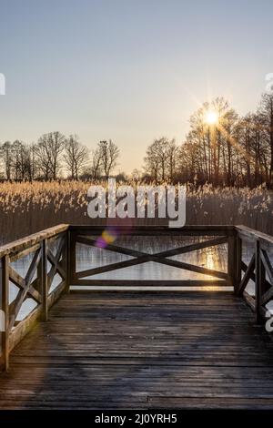 A wooden Bridge on a lake Mamry in Trygort on a sunny day. Stock Photo