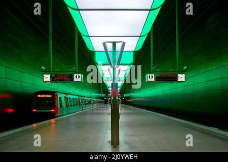 Subway station with green lights at University on the Speicherstadt area in Hamburg Stock Photo