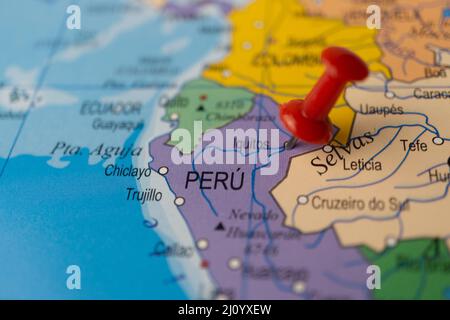 peru marked on the map with a red pin, travel destination, planning. out of focus background Stock Photo