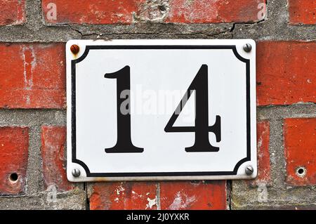 White house number plaque, showing the number fourteen Stock Photo