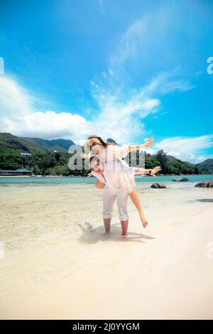 Happy couple enjoys life on a tropical paradise island, Seychelles Stock Photo