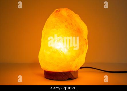 Orange salt lamp. Orange light himalayan lamp Stock Photo