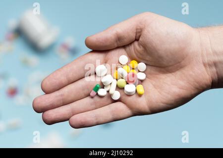 Flat lay hand holding assortment pills Stock Photo