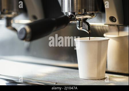 Machine pouring coffee disposable cup Stock Photo