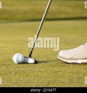 Man using club hit golf ball Stock Photo