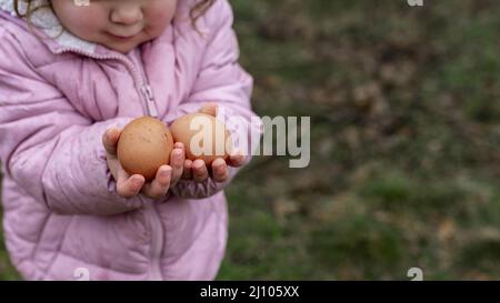 Close up kid holding eggs Stock Photo