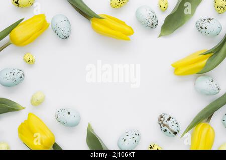 Flat lay eggs easter with tulips frame Stock Photo