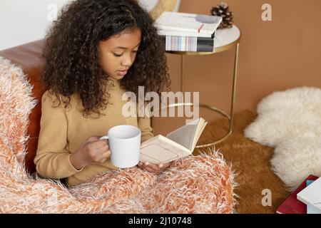 Medium shot girl reading book Stock Photo