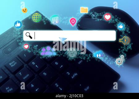 Search bar with virtual icons floating over computer keyboard and copy space. Concept of searching browsing Internet data information. Stock Photo
