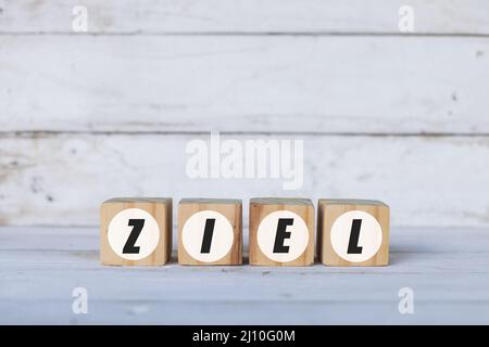 ziel concept written on wooden cubes or blocks, on white wooden background. Stock Photo
