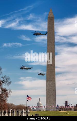 Helicopters in flight at the Washington Monument with US President, Washington, DC, USA Stock Photo