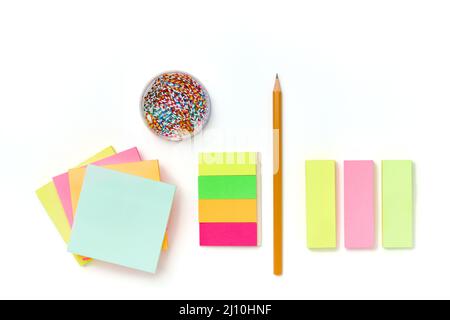 Colorful paper notes, paper clip and pencil on white background Stock Photo