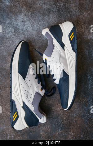 Pair of mens sneakers on abstract background, athletic shoes, lifestyle, close-up Stock Photo