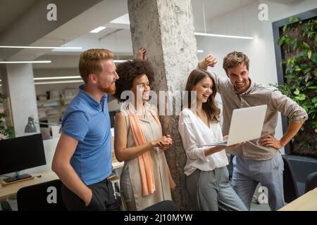 Group of software engineers working developing applications together in corporate office Stock Photo