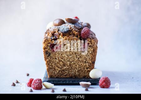 Easter cake with chocolates and raspberry. Sliced. Close up. Stock Photo