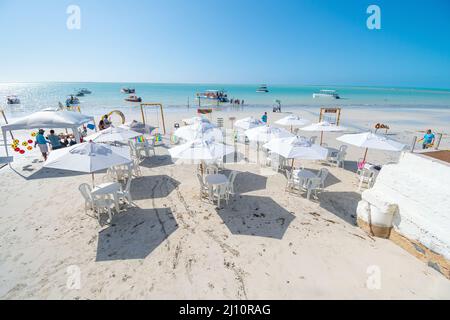 Maragogi, AL, Brazil - October 17, 2021: view to the beach umbrellas in front of Marazul restaurant on Barra Grande beach during morning. Stock Photo