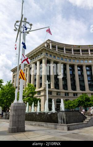 Vertical shot of fountains and a part of the building of US Navy Memorial Plaza Washington DC, USA Stock Photo