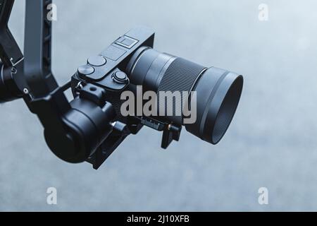 Mirrorless camera mounted on 3-axis electronic gimbal Stock Photo