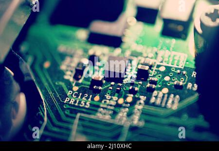 Old dusty and dirty laptop circuit board close-up. Stock Photo